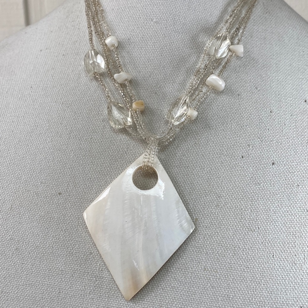 Polished shell and clear seed bead necklace